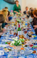 The people at the Banquet. A solemn event in the enterprise. Anniversary or wedding. Snacks and alcohol on the tables. Served buffet style. Catering.