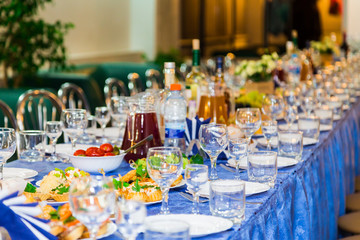 Served tables at the Banquet. Drink, alcohol, delicacies and snacks. Catering. A reception event.