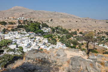 Lindos, a medieval village with small white houses on the hillside making it one of the most...