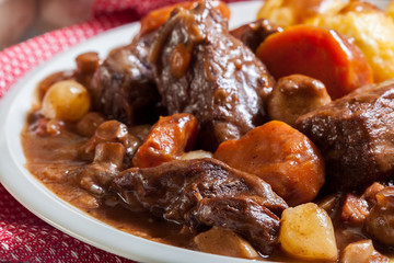 Beef Bourguignon stew served with baked potatoes