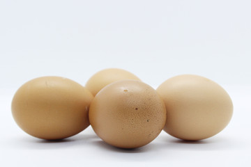 Close-up view of organic Brown Eggs on Plastic Egg Carton isolated on white background