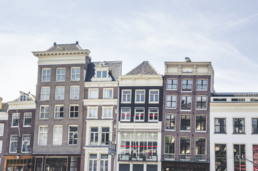 Traditional old buildings and boats in Amsterdam, Netherlands. Canals of Amsterdam.