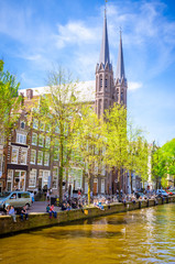 Naklejka premium Traditional old buildings and boats in Amsterdam, Netherlands. Canals of Amsterdam.