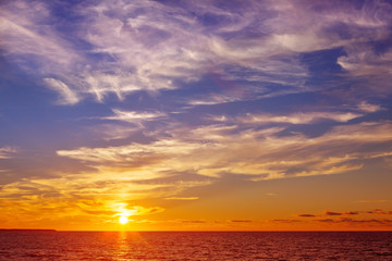 Naklejka na ściany i meble Beautiful marine sunset with orange Cirrus clouds