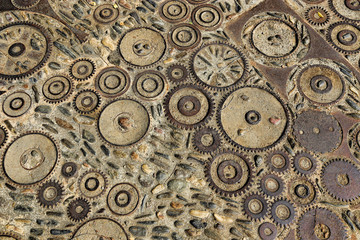 Fototapeta na wymiar Unusual floor with pattern from pebbles and metal details