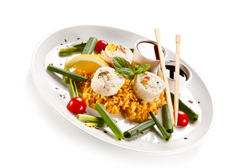 Roast, stuffed chicken roulade with rice and vegetables on white background 