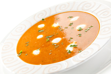 Tomato soup with cream on white background 