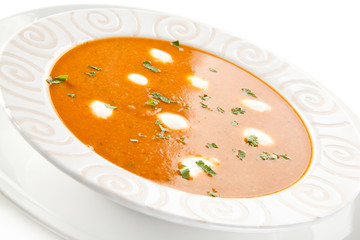 Tomato soup with cream on white background 