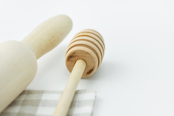 Wood Honey Dipper Rolling Pin on White and Beige Checkered Cotton Kitchen Towel. Tabletop. Baking Essentials. Organic Produce. Holidays Christmas Easter. Clean Minimalist Style. Copy Space