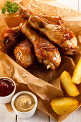     Grilled chicken legs with baked potatoes and vegetables 