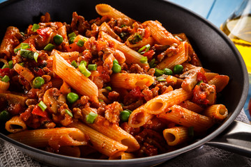 Penne with meat, tomato sauce and vegetables 