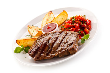 Grilled steak, baked potatoes and vegetable salad on white background 
