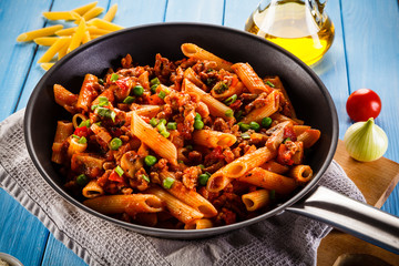 Penne with meat, tomato sauce and vegetables 