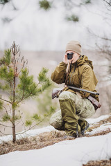 female hunter ready to hunt, holding laser finder in forest. hunting and people concept © kaninstudio