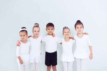 Cute little kids dancers on white background. Choreographed dance by a group of small ballerinas...