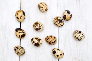Several quail eggs on a wooden background. flat lay