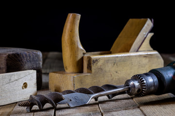 Old good carpentry, tools drill bit. Wooden carpentry table and old good carpentry tools on it.