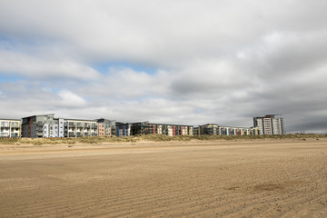 Fototapeta na wymiar Modern beach front apartments with a blue sky 