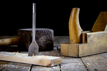 Old good carpentry, tools drill bit. Wooden carpentry table and old good carpentry tools on it.