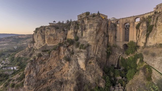 Canyon Tajo de Ronda - Spain - time lapse. Beautiful landscape with the illumminated bridge - impressive view
