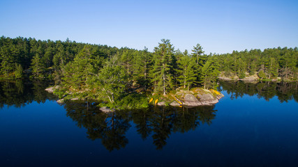Aerial view of camping on the edge of a river during a family canoe trip