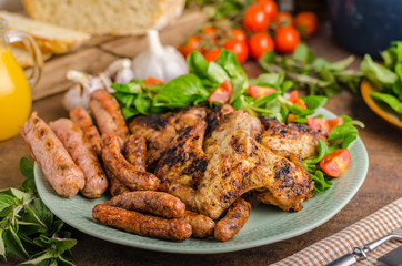 Grilled chicken wings and sausages