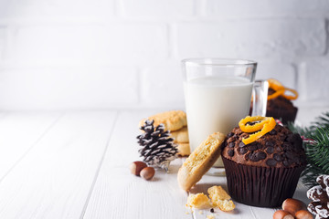 Freshly baked homemade chocolate muffins with jug with milk