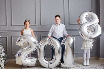 Fototapeta na wymiar three children with large numbers 2018