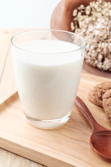 Milk in glass on wooden background