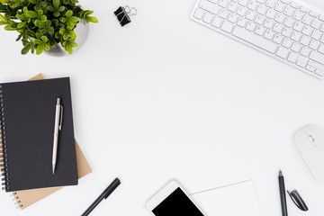 White office desk table with a lot of things on it. Top view with copy space, flat lay.