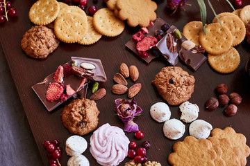 Delicious sweets on candy buffet. different sweets on a wooden table