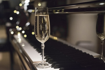 a glass of champagne and piano