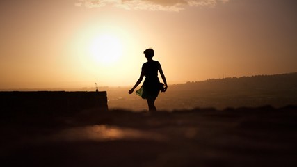 Fototapeta na wymiar Silhouette of female person on the top of Castle in Ankara, Turkey