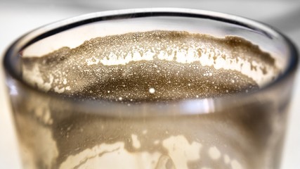 Macro texture of empty glass of Cortado - Spanish coffee with milk,