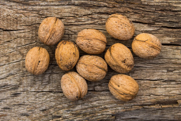 Walnuts on rustic old wooden table. Top view