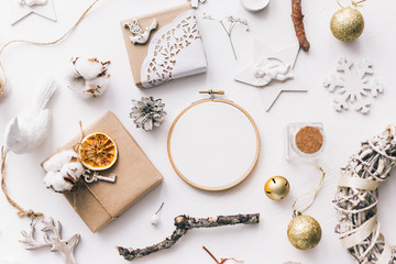 Flat lay top view Christmas photo with an embroidery hoop and cute decoration. © Senpo