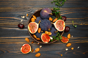 Figs and nuts on wooden background