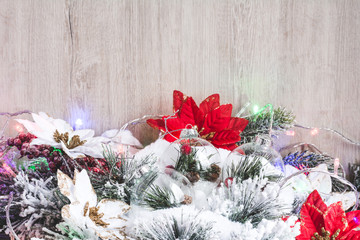 Christmas decor. Christmas or New Year background: Christmas flowers poinsettia, Christmas tree, tree branches and garland