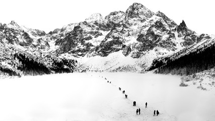 Black and white winter landscape of frozen Morskie Oko Lake and snowy Tatra Mountains in Lesser Poland. © Serdar