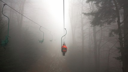 People on the Mountain lift in foggy weather