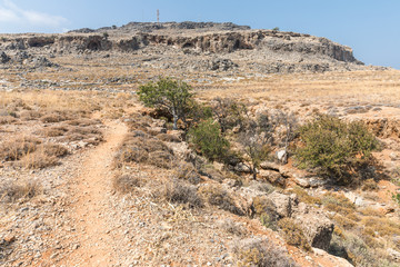 Fototapeta na wymiar Stony landscape on the way to the Kleoboulous's tomb in Lindos on the Rhodes Island, Greece. 