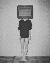 Young woman standing behind the retro tv
