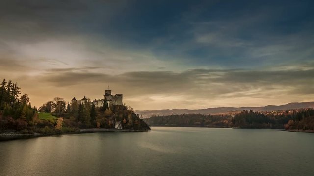 Niedzica castle by lake in autumn at sunset, Poland, Timelapse