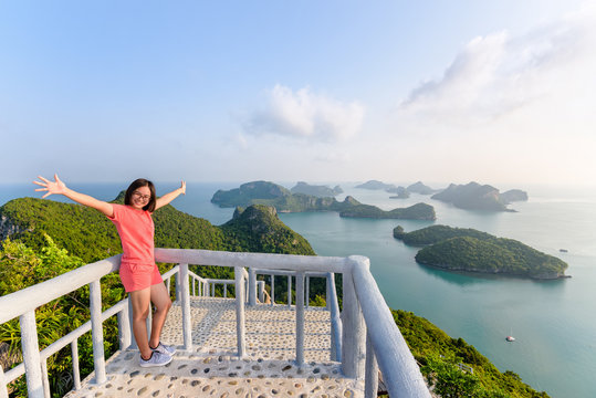 Woman tourist on the balcony is peak view point of Ko Wua Ta Lap island and beautiful nature landscape during sunrise over the sea in Mu Ko Ang Thong National Park, Surat Thani, Thailand