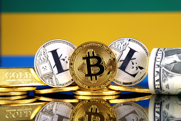 Physical version of Bitcoin, Litecoin, gold, US Dollar and Gabon Flag. Conceptual image for investors in cryptocurrency, gold and dollars.