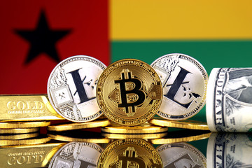 Physical version of Bitcoin, Litecoin, gold, US Dollar and Guinea Bissau Flag. Conceptual image for investors in cryptocurrency, gold and dollars.
