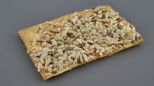 Vegan crunchy cookies with sunflower, flax seeds and sesame seeds isolated on gray background