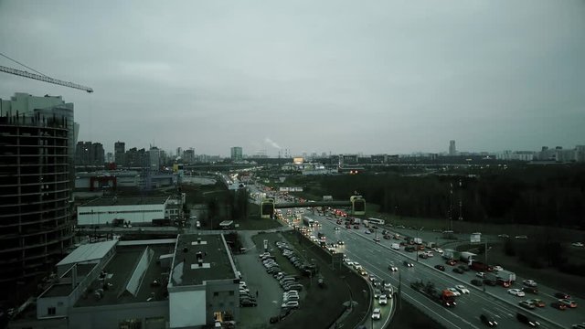 Aerial rising shot of big city highway intersection in the evening rush hour. Moscow, Russia