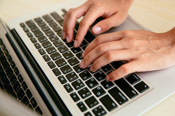 Fototapeta na wymiar Woman's hands typing on a laptop