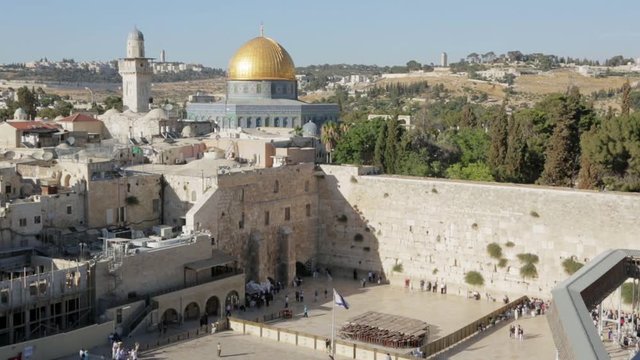 Wailing Wall and Dome of the Rock Timelapse. Timelapse of people coming and going in front of the Wailing Wall in Jerusalem, with the Temple Mount, Dome of the Rock and the Mount of Olives behind.